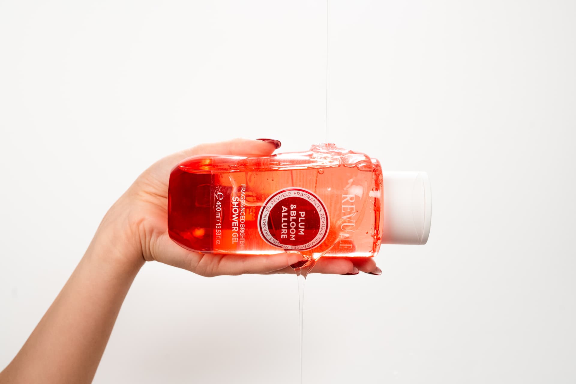 PLUM & BLOOM ALLURE Fragranced Brightening Shower Gel Plum & Bloom Allure — packshot in use