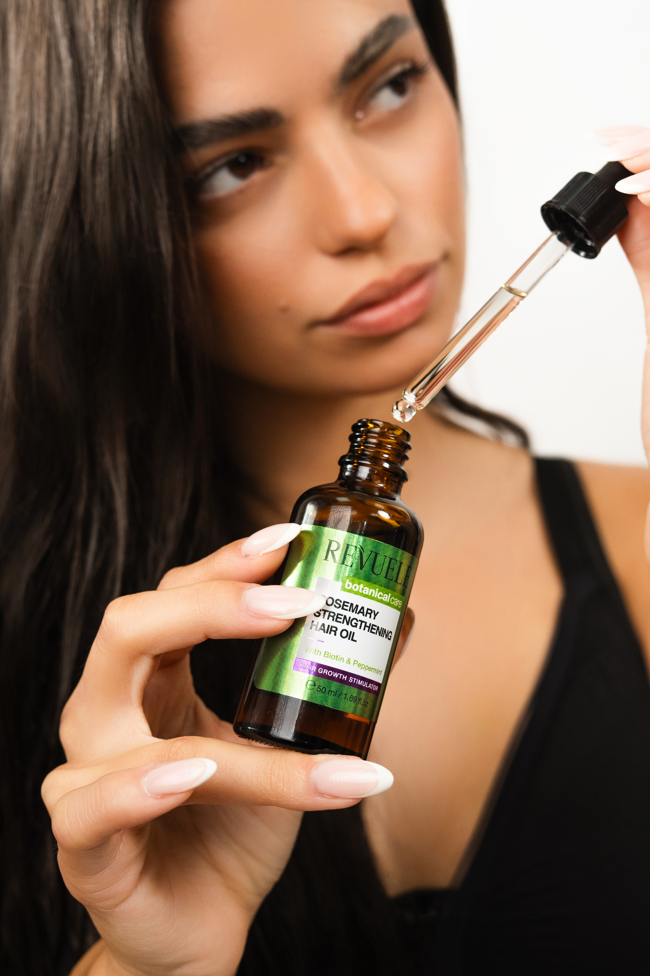 ROSEMARY HAIR GROWTH LINE Strengthening Hair Oil — packshot in use
