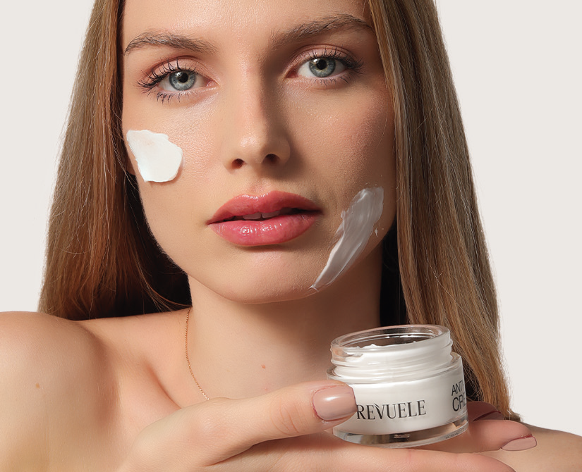 Woman applying REVUELE face cream